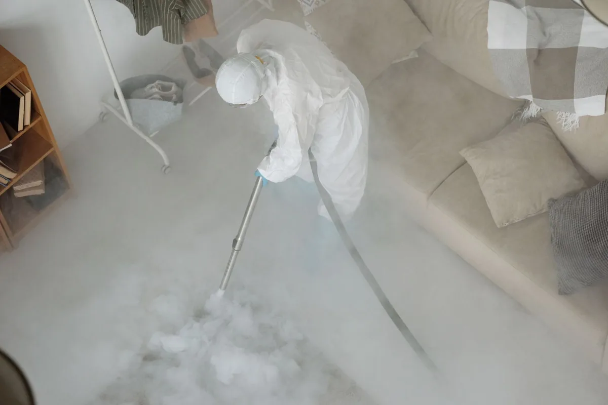 Biohazard cleanup technician in protective equipment, Goldstream, AK